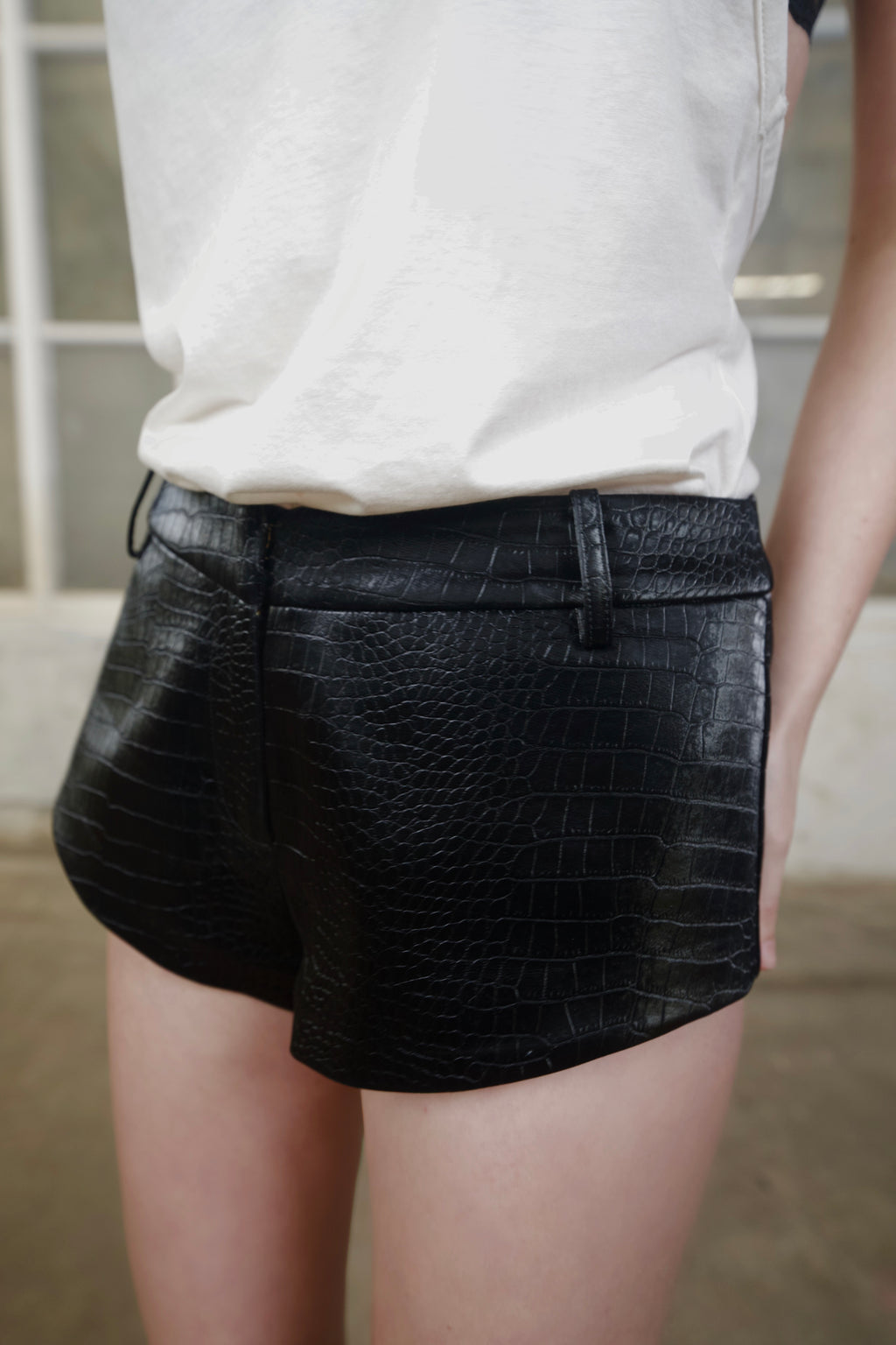Close-up of the black crocodile-effect faux leather texture on 3SPIRIT The Micro Shorts
