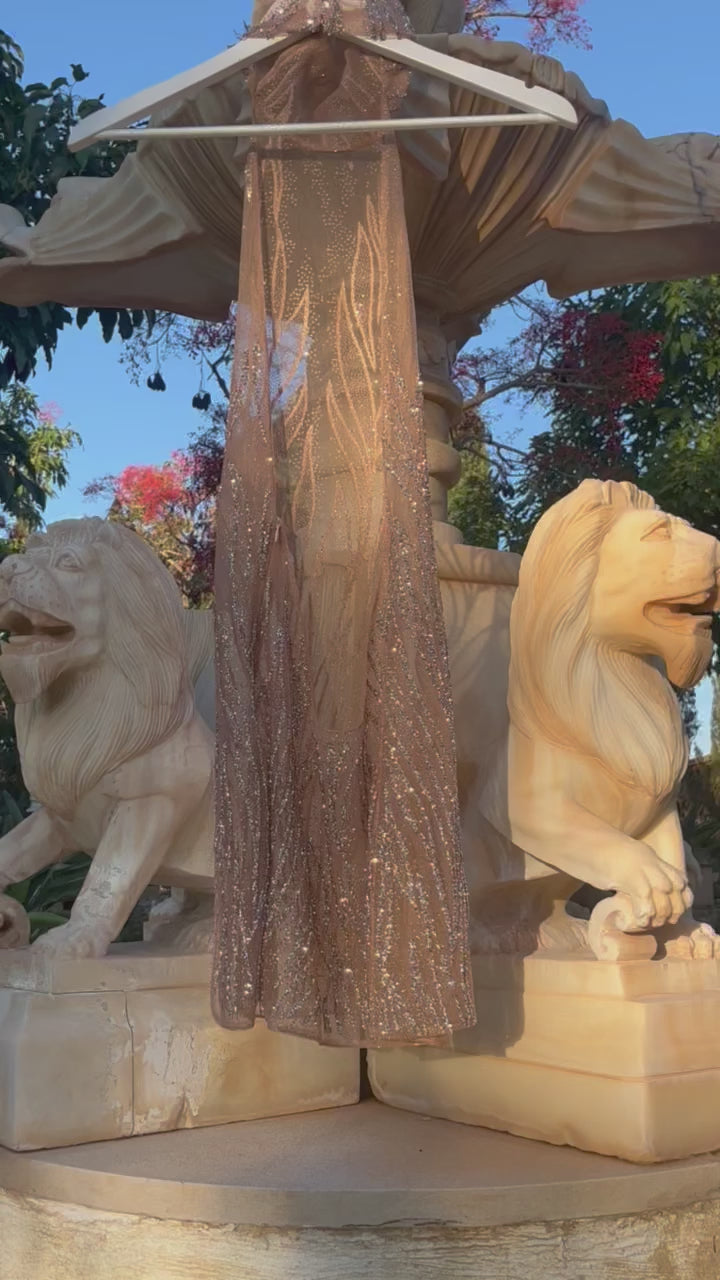 Martini dress featuring a high neck, low back, and sheer embellishments for a seductive and elegant look